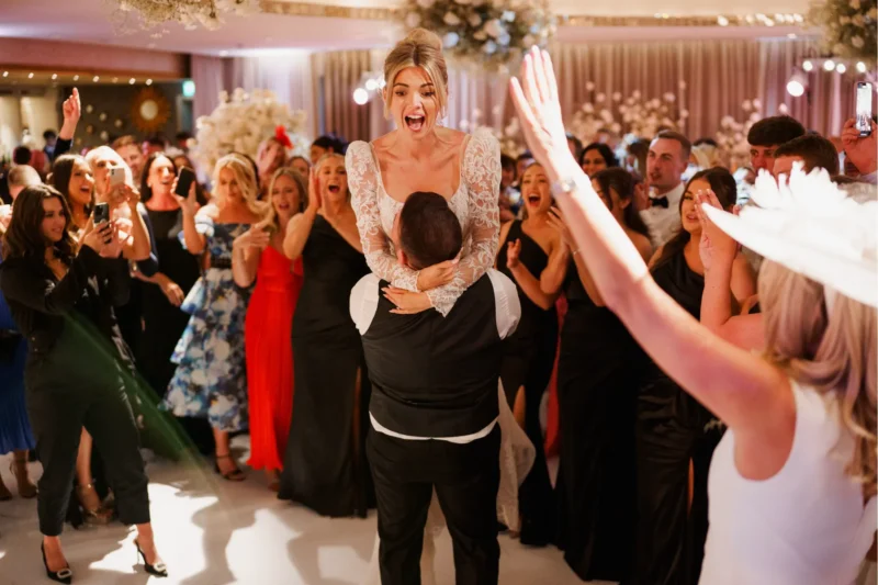 Bride being lifted into the air during an iconic moment on the dancefloor at a Grantley Hall wedding in Yorkshire.