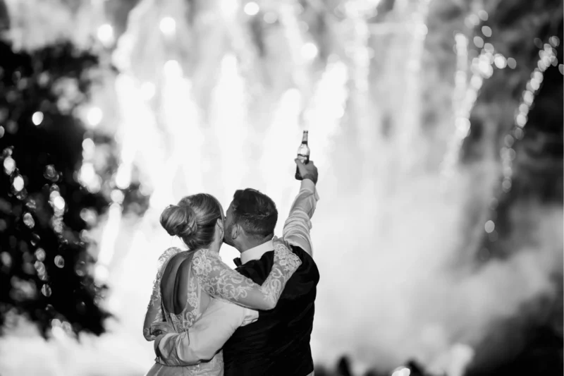 Bride and groom celebrating during fireworks at a Grantley Hall wedding in Yorkshire.