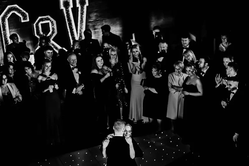 Beautiful black and white wedding photo as a bride dances with her groom during a wedding at Peckforton Castle by wedding photographer ARJ Photography®