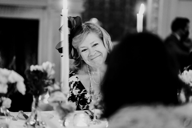 The groom's mum looks lovingly at the bride at a London Claridge's wedding - powerful black and white wedding photography by ARJ Photography®
