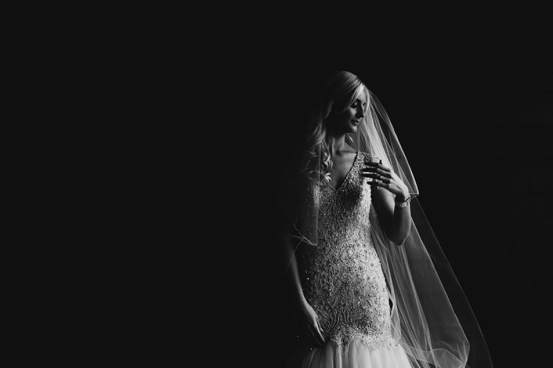 A black and white dramatic fashion inspired portrait of a bride - powerful black and white wedding photography by ARJ Photography®