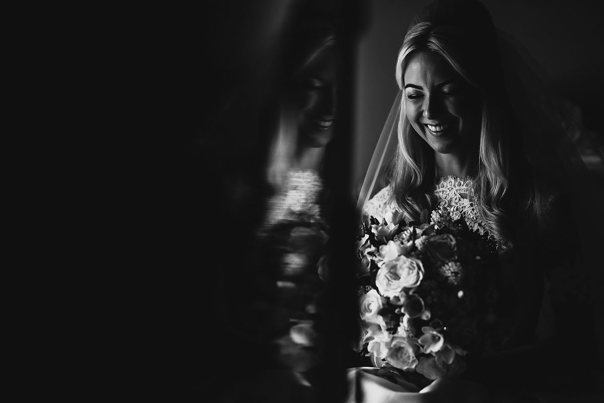 A black and white portrait of a laughing bride - powerful black and white wedding photography by ARJ Photography®