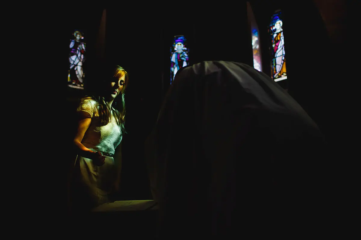 Artistic photo of a bridesmaid at a church wedding - artistic wedding photography by ARJ Photography®