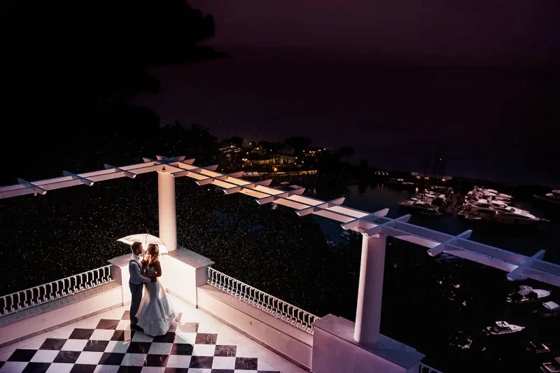 Amazing epic photo of a bride and groom on a rooftop dramatically lit at night in Sorrento Italy - artistic wedding photography by ARJ Photography®