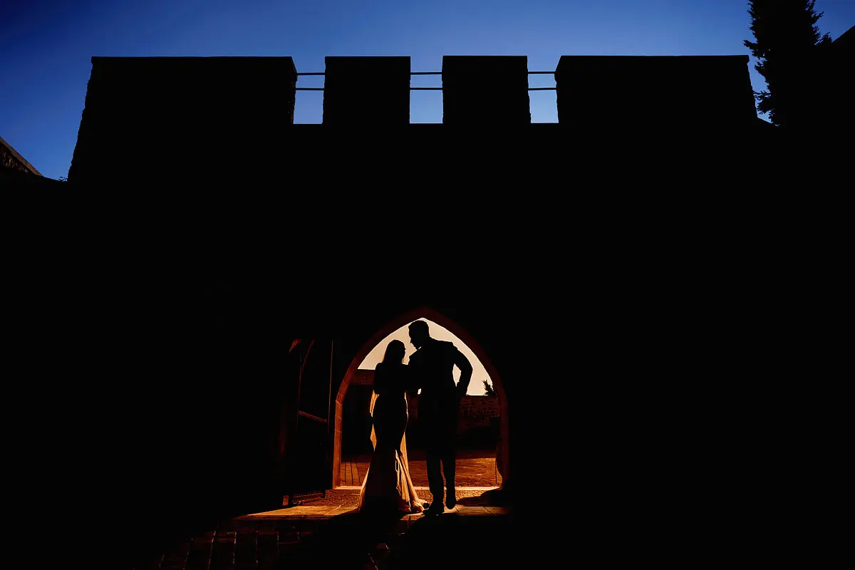 A colourful silhouette of a bride and groom at a chateau wedding in France - artistic wedding photography by ARJ Photography®