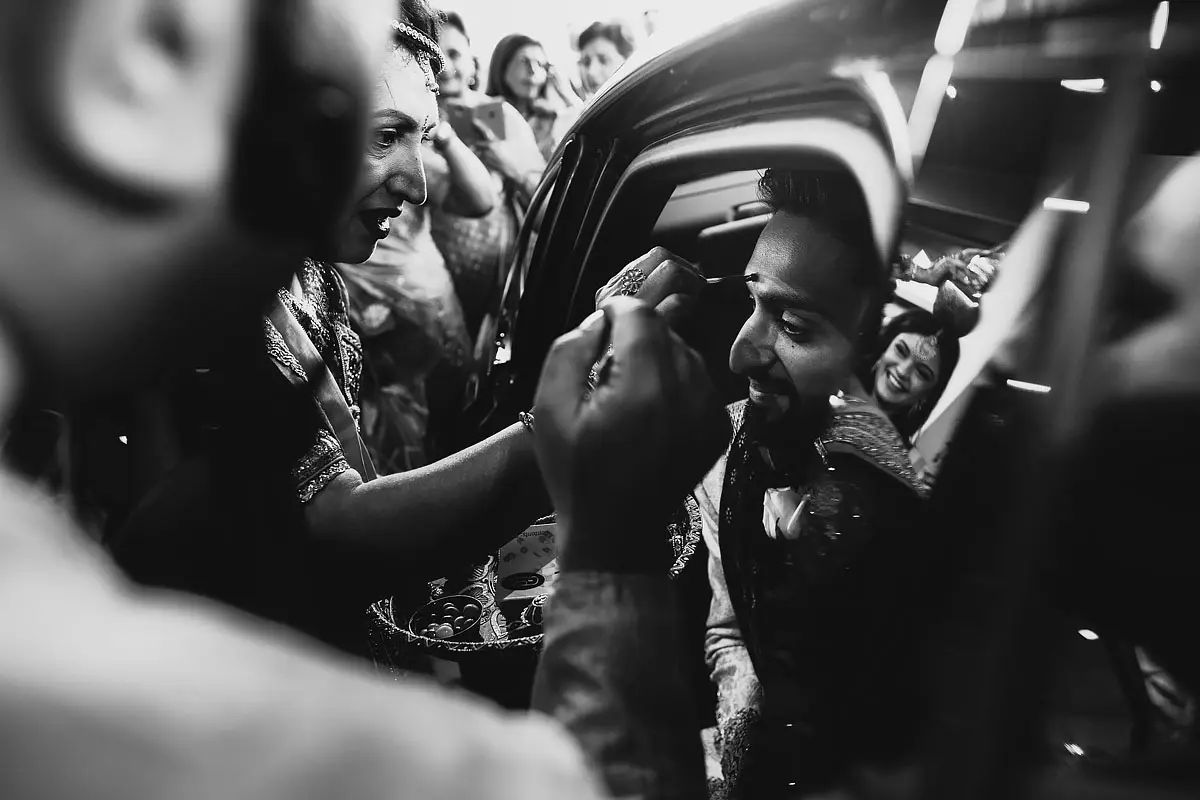 A dramatic black and white photo of a groom arriving for his Indian wedding ceremony - artistic wedding photography by ARJ Photography®