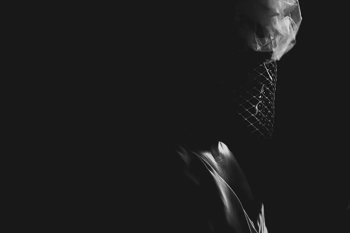 A cool and unique black and white portrait of a bride getting ready for her destination wedding in France - artistic wedding photography by ARJ Photography®