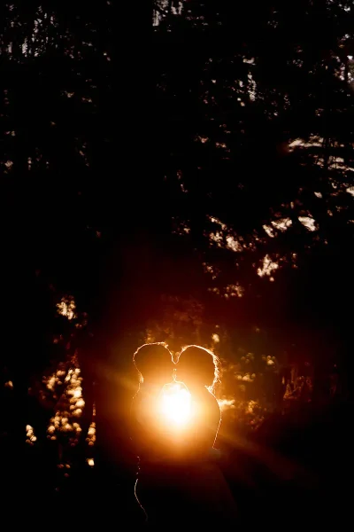 A very dramatic sunset wedding portrait of a bride and groom kissing - artistic wedding photography by ARJ Photography®