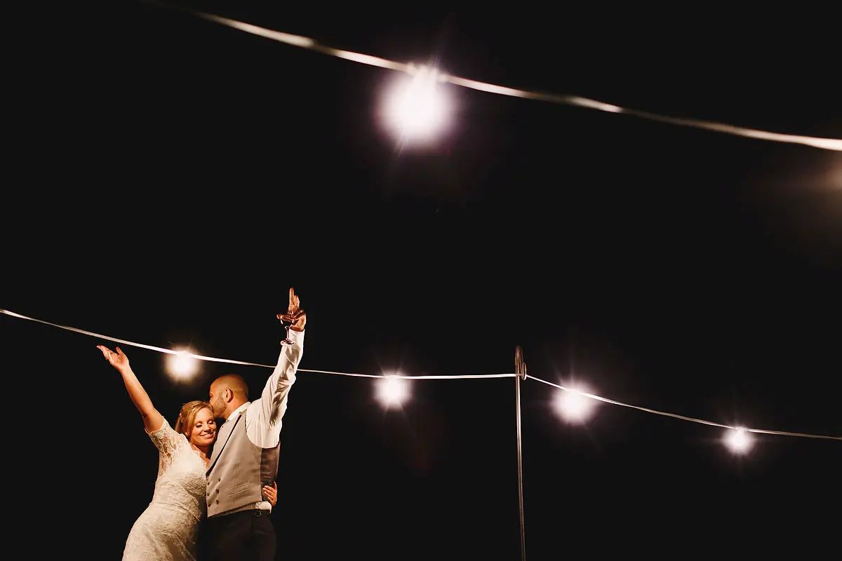 Dramatic and cool night portrait of a bride and groom having fun at a wedding - artistic wedding photography by ARJ Photography®