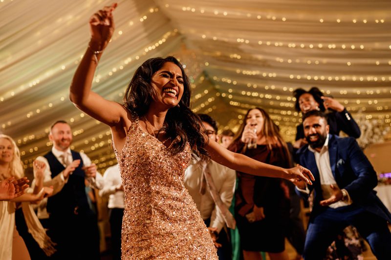 A bride enjoying the music at her wedding party - epic wedding party photo by ARJ Photography®
