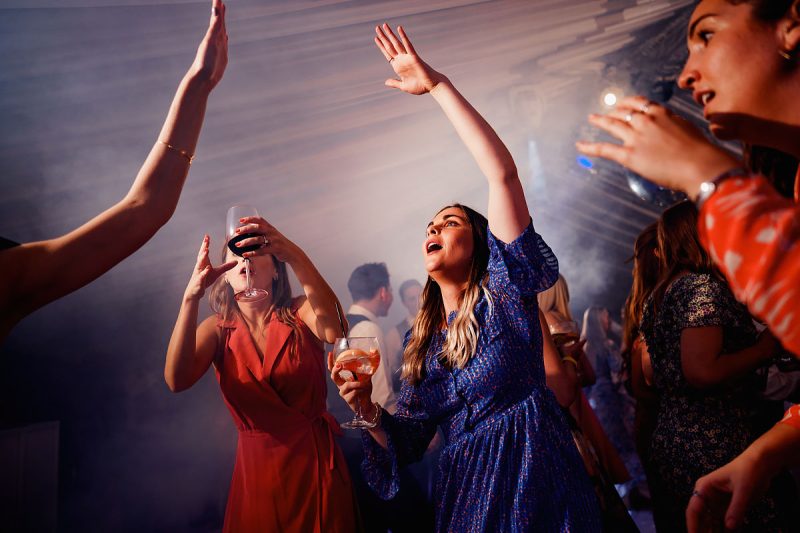 Wedding guests dancing in a marquee wedding dance floor - epic wedding party photo by ARJ Photography®