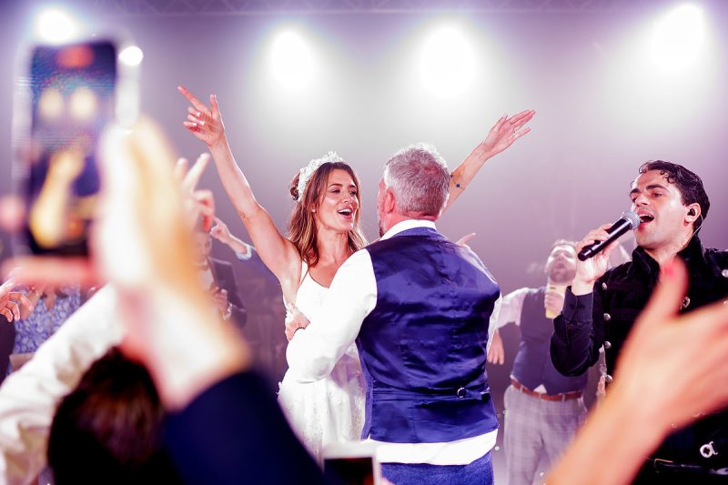 A bride and groom singing and dancing together at the end of their wedding party in Cheshire - epic wedding party photo by ARJ Photography®