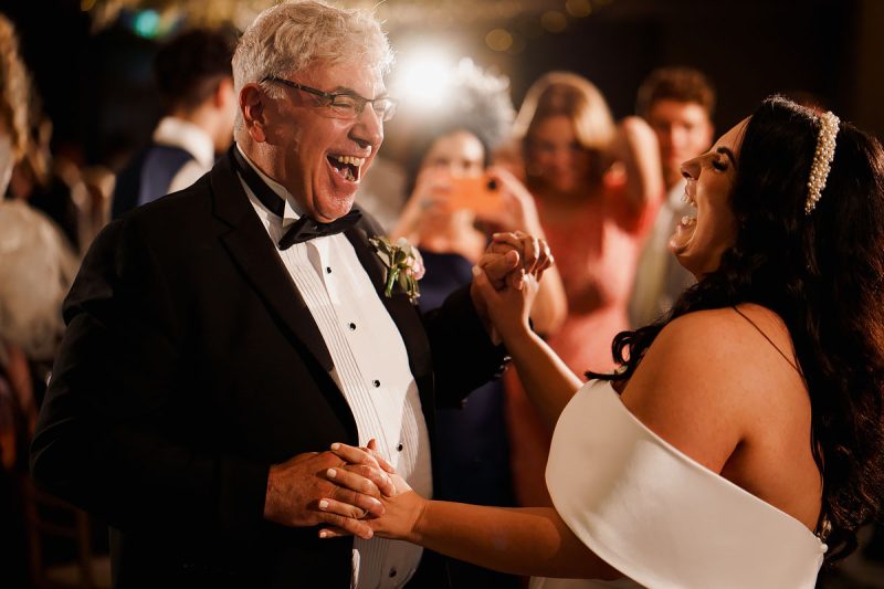 A bride dances with the very happy father of the bride at a wedding party - epic wedding party photo by ARJ Photography®