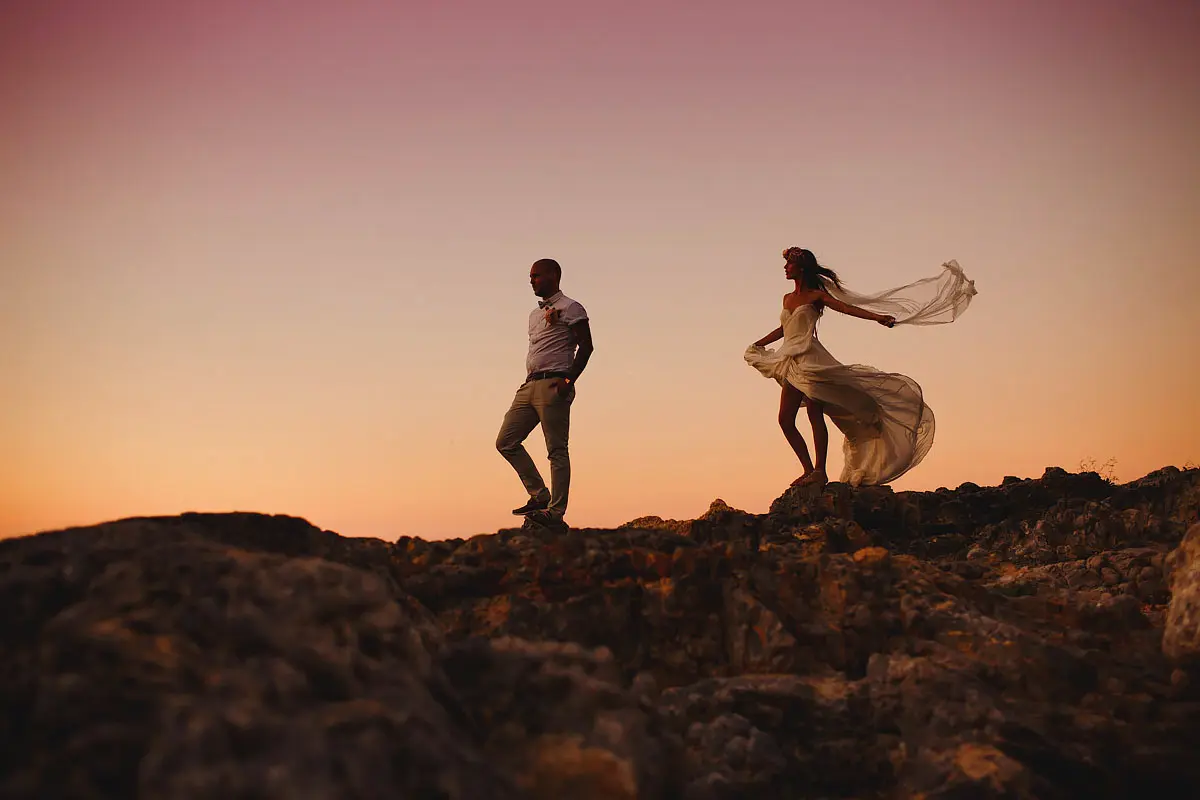 Evening portrait of a bride and groom on a rocky beach at a destination wedding in Rhodes Greece by destination wedding photographer ARJ Photography®