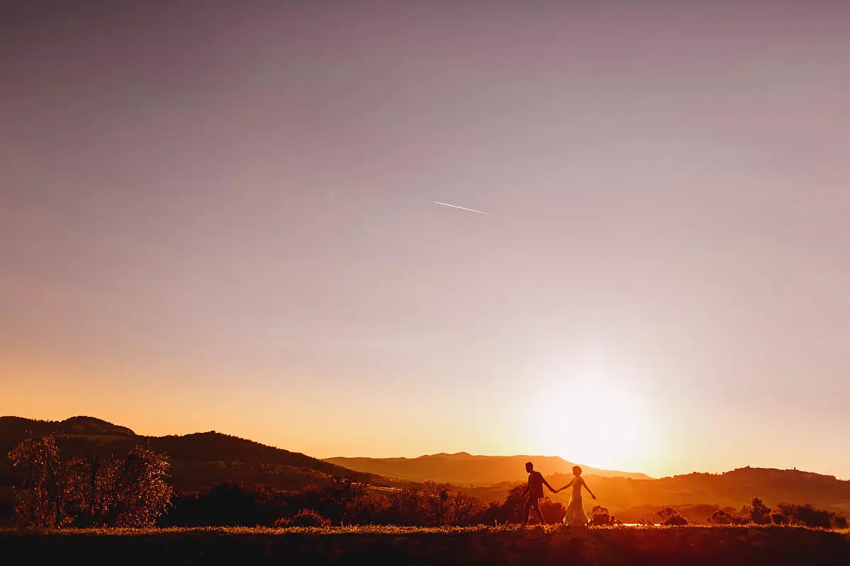 Beautiful photo of a bride and groom walking at a destination wedding in Tuscany Italy by destination wedding photographer ARJ Photography®