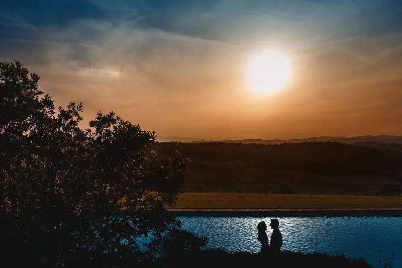 Creative destination wedding photo of a bride and groom at sunset in Tuscany Italy by destination wedding photographer ARJ Photography®