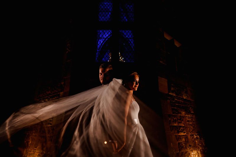 Night time artistic wedding portrait of a bride and groom at their castle wedding venue - incredible wedding portraits by ARJ Photography®