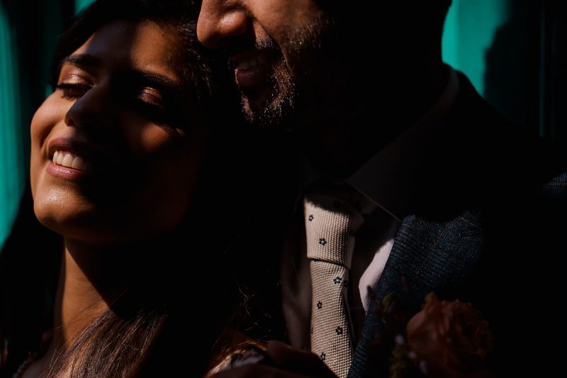 Creative artistic wedding portrait of a bride and groom dramatically lit by some sunlight coming through a window - incredible wedding portraits by ARJ Photography®