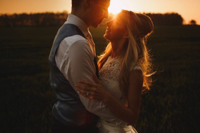 A romantic sunset wedding portrait of a bride and groom hugging - incredible wedding portraits by ARJ Photography®