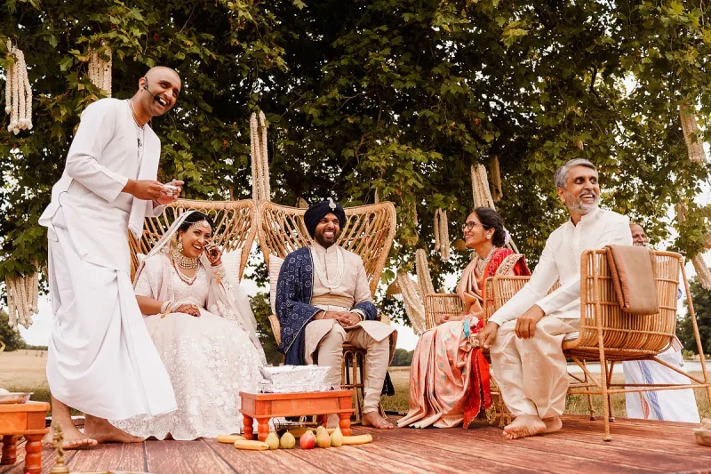 A happy moment of laughter during a Hindu outdoor wedding ceremony - Unique Indian wedding photos by ARJ Photography®