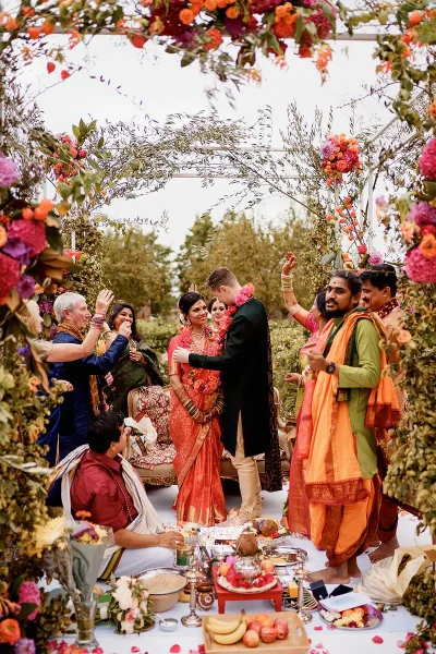 A beautiful happy busy scene during an outdoor Hindu wedding ceremony - Unique Indian wedding photos by ARJ Photography®